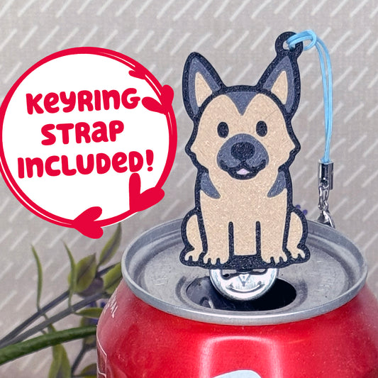 A tan and black German Shepherd-inspired Tab Buddy rests atop an open can tab. Desecriptive text reads "Keyring Strap Included!"