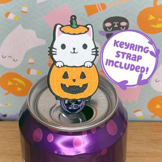 Halloween-themed cat-in-pumpkin Tab Buddy with keyring strap on a purple can with a colorful background featuring pumpkins and ghosts.