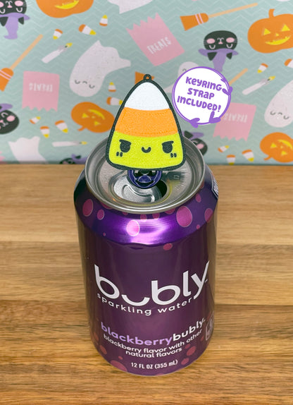 Purple can of sparkling water with a candy corn-shaped Tab Buddy on a wooden surface with text reading 'keyring strap included!'