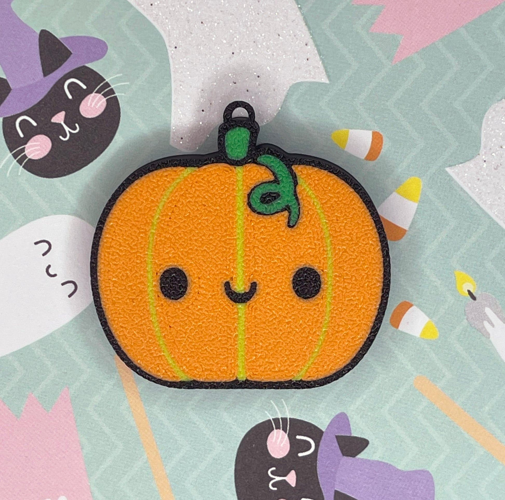 Cute pumpkin Tab Buddy with smling face and black outline on a colorful Halloween-themed background