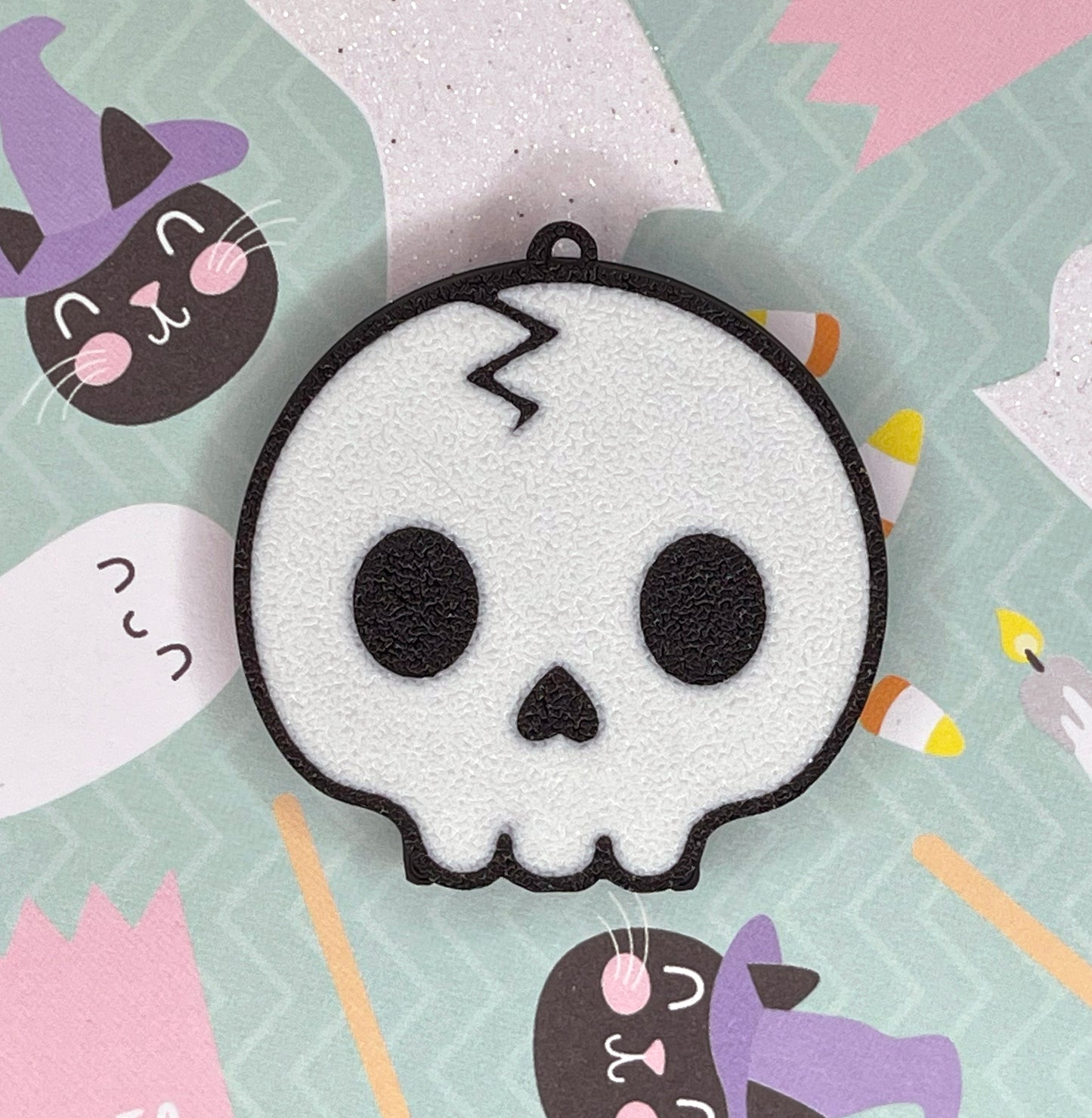 Skull-shaped Tab Buddy on a colorful Halloween-themed background