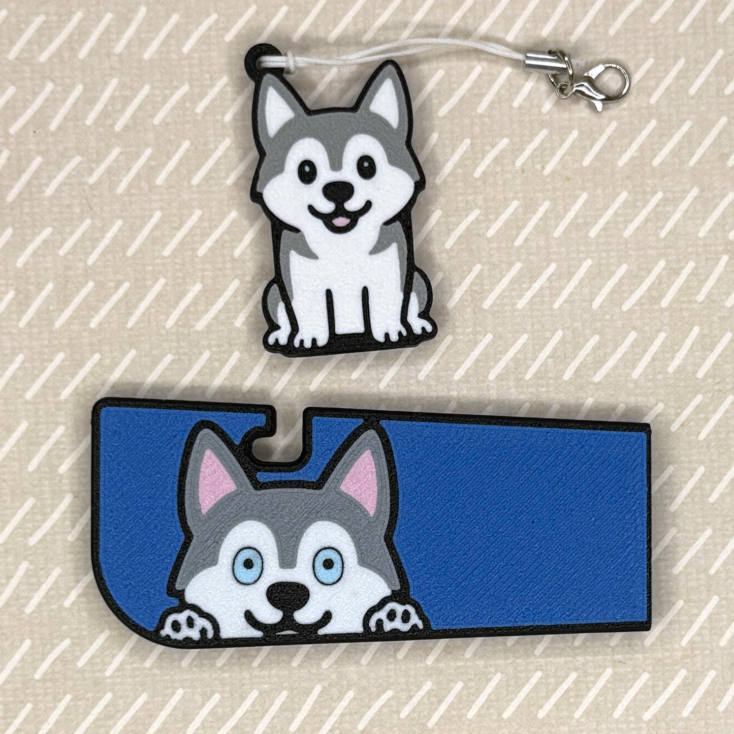 A husky dog-design Tab Buddy XL and matching soda-sized Tab Buddy rest atop a beige surface.