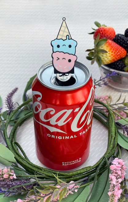 Coca-Cola can with a Ice cream cone Tab Buddy on top, surrounded by strawberries and flowers.