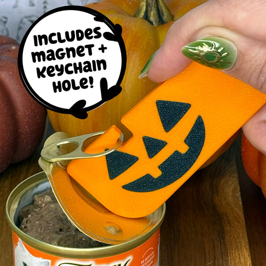 Orange Tab Buddy XL can opener with jackolantern design held over a can, surrounded by pumpkins.