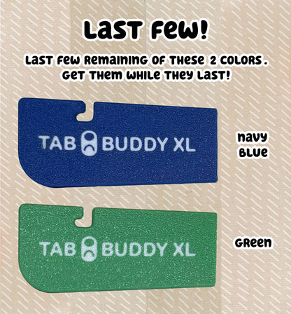 Two Tab Buddy XL products, one navy blue and one green, on a beige background with text stating "last few" of these colors.