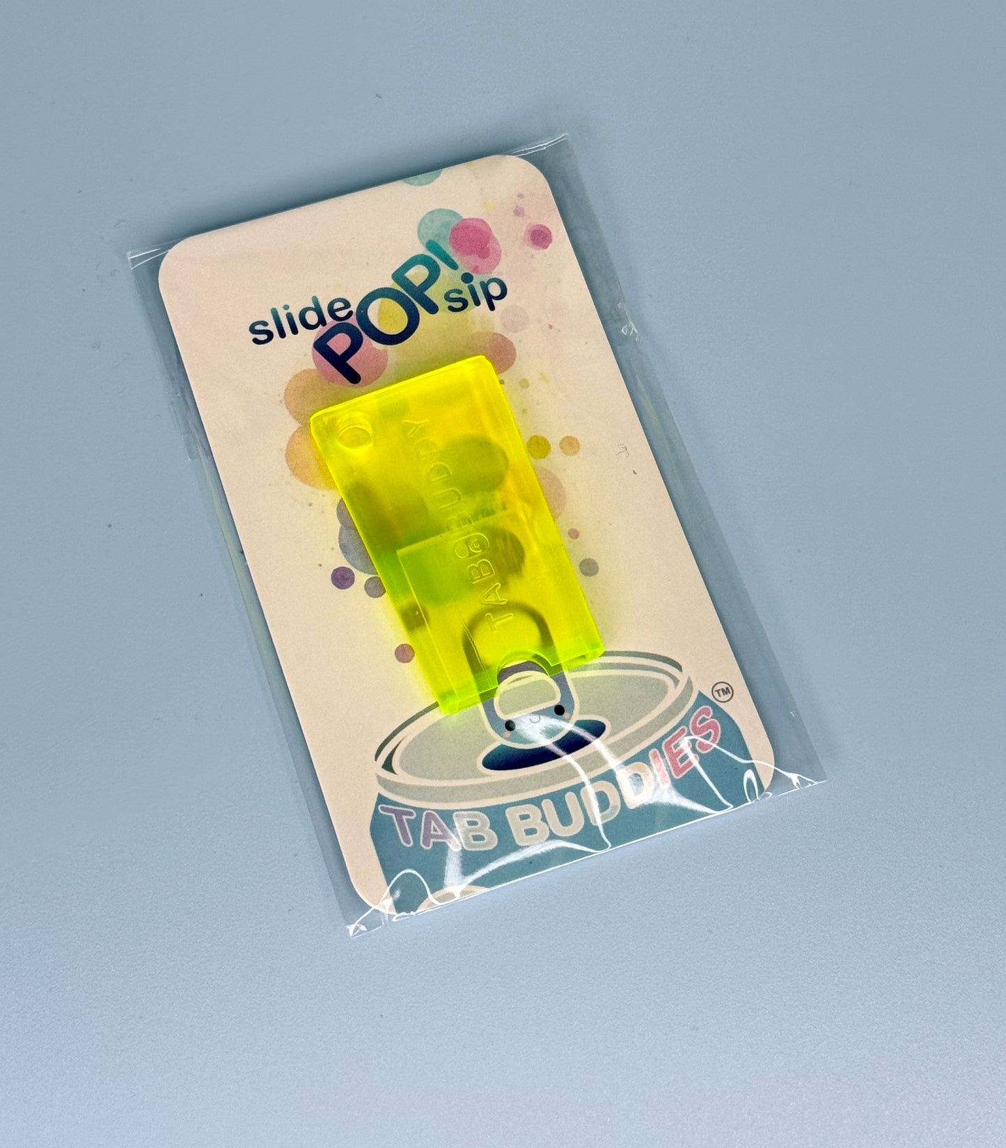 Electric yellow Tab Buddy Mini in packaging with 'Tab Buddies' branding on a gray background