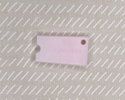 Pink Tab Buddy Mini on a textured beige background