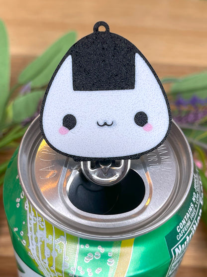 Cute black and white onigiri rice ball-shaped Tab Buddy on a can with a blurred background