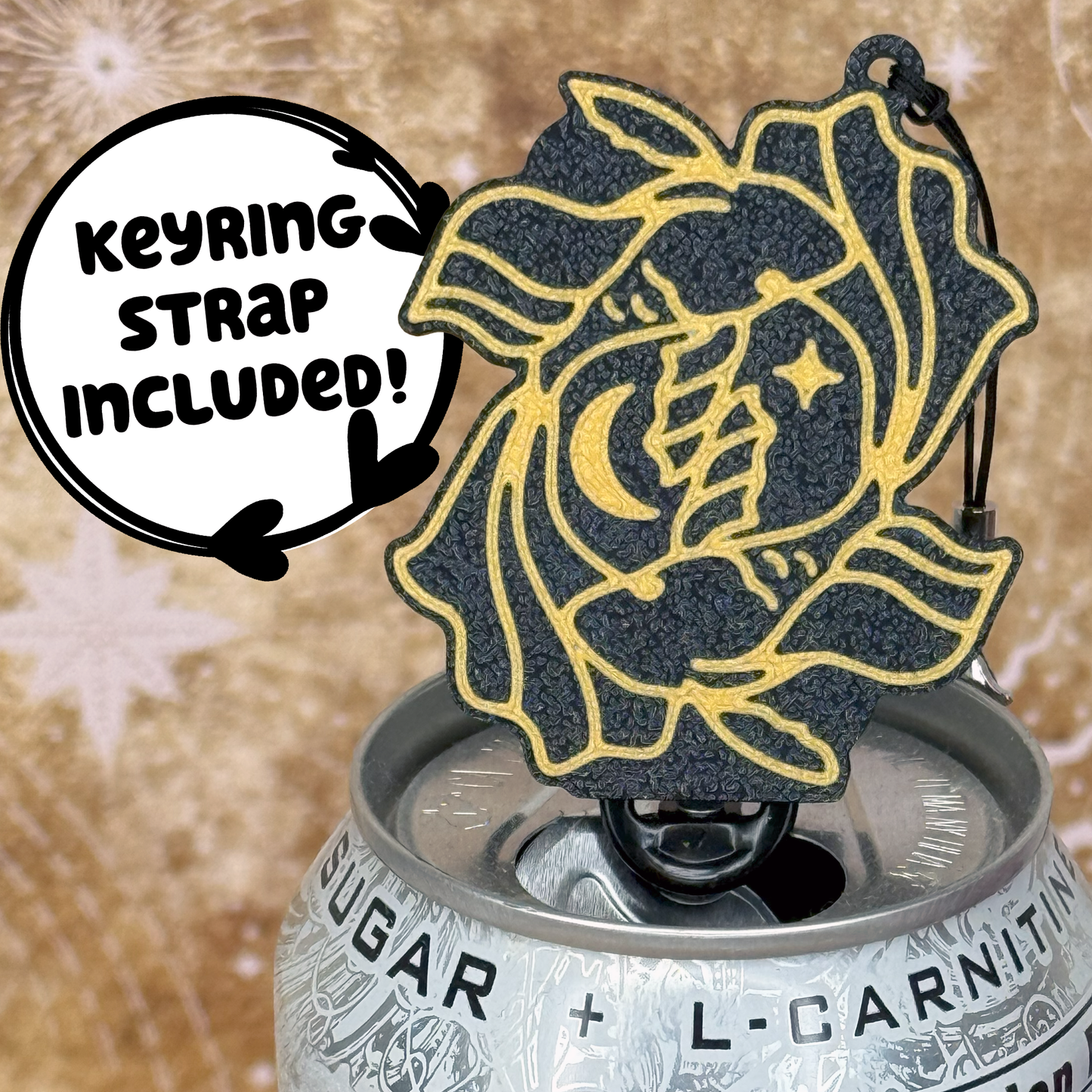 Pisces design Tab Buddy with Keyring strap sits atop a can with decorative starry background 