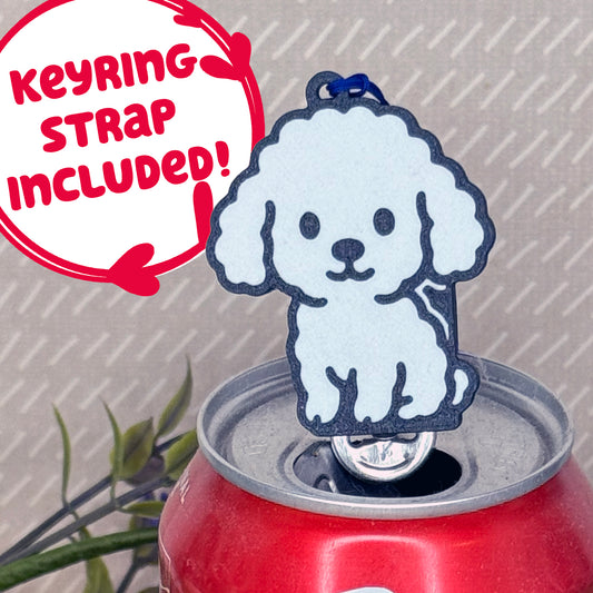 A White Poodle-inspired Tab Buddy rests atop an open can tab. Desecriptive text reads "Keyring Strap Included!"