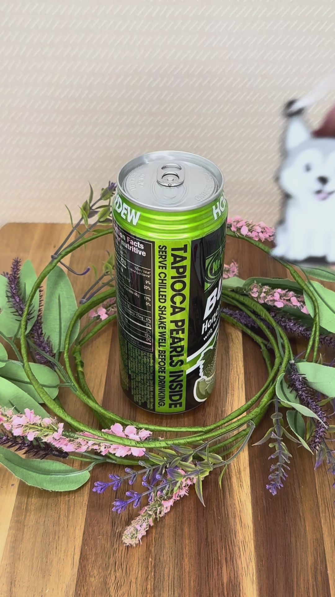 A soda-sized Husky Tab Buddy is used to open a can of bubble tea. More cute dog Tab Buddies are shown.