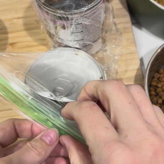 Tab Buddies Reusable Can lids are shown being used to store opened cans  of pet food and other canned foods. The lids stretch to fit most standard sizes of canned foods.
