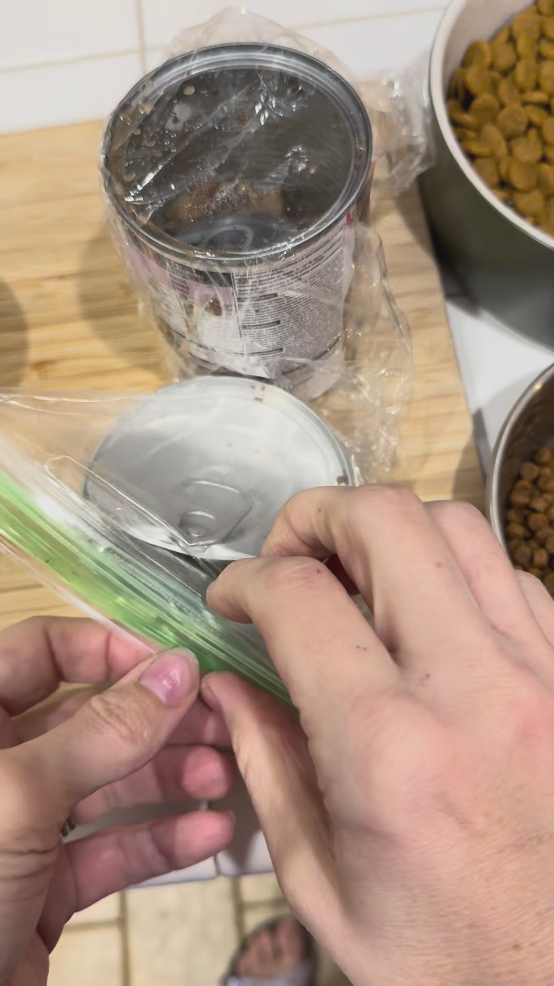 Tab Buddies Reusable Can lids are shown being used to store opened cans  of pet food and other canned foods. The lids stretch to fit most standard sizes of canned foods.