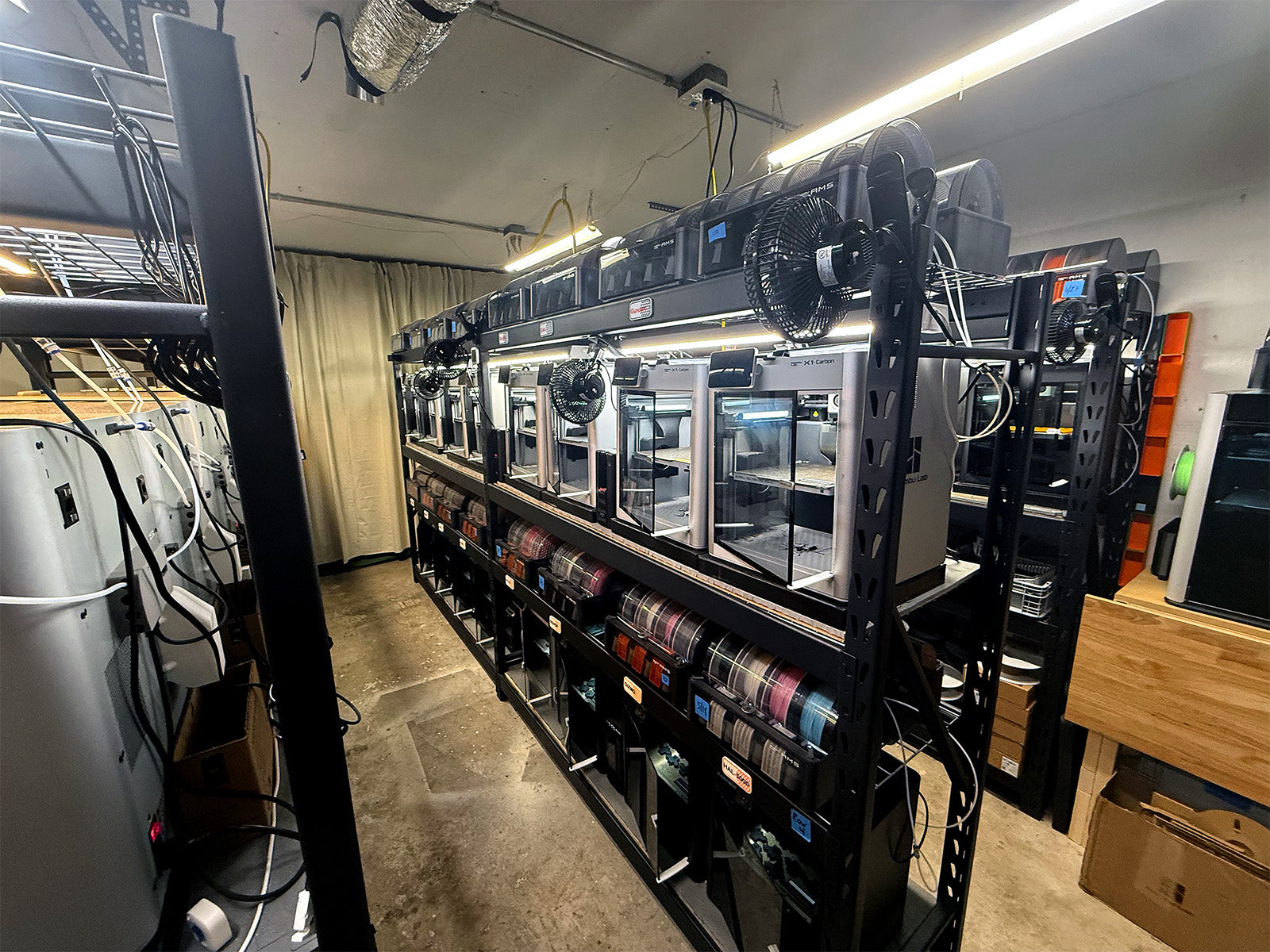 Rows of 3D printers line the Tab Buddies workshop