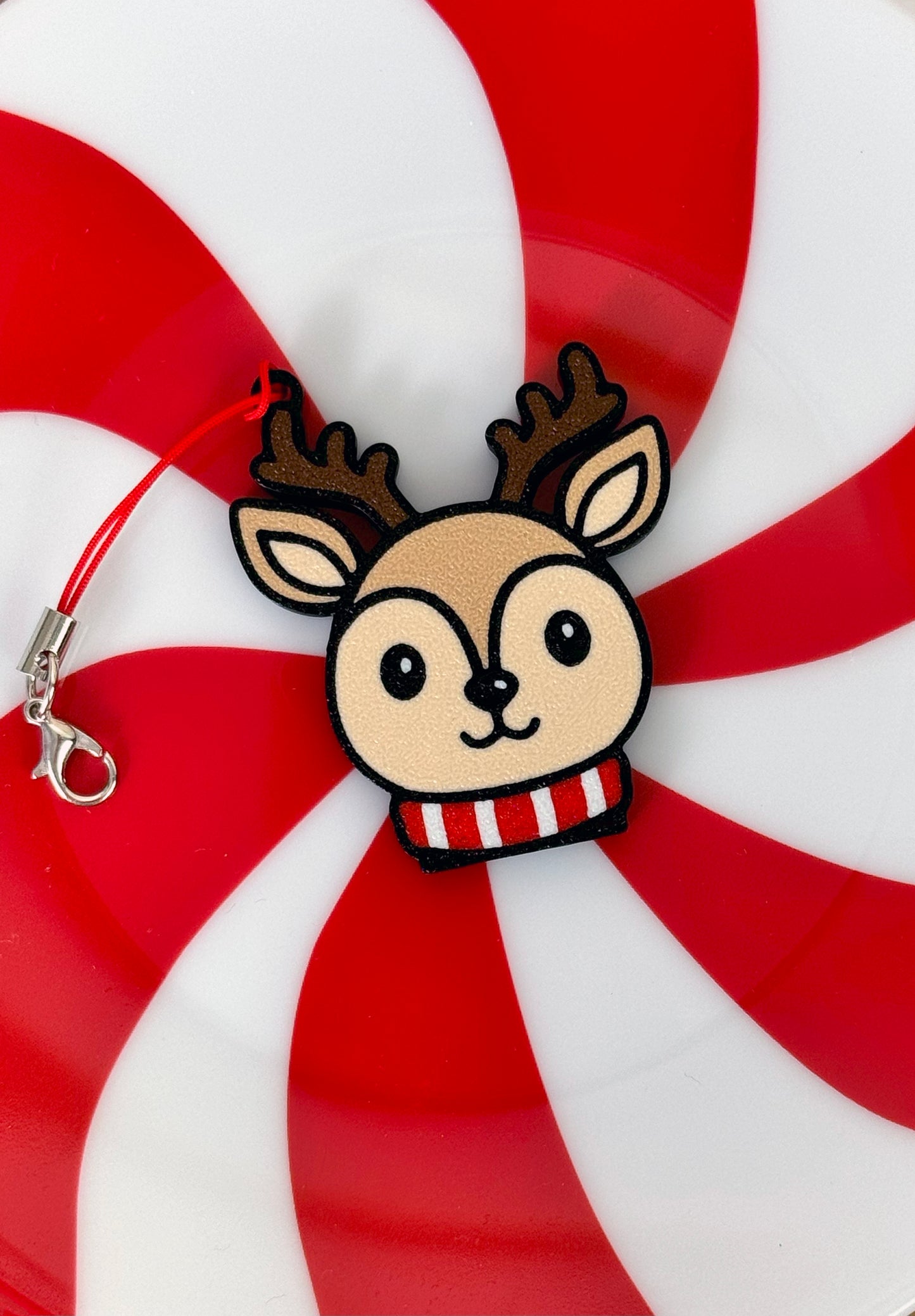 Cartoon style reindeer Tab Buddy on a red and white striped background