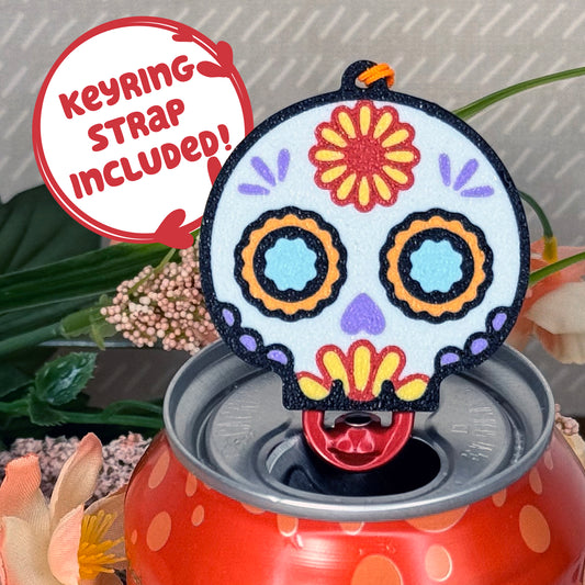 Sugar skull shaped Tab Buddy with keyring  strap on a colorful can against a floral background
