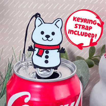 Coca-Cola can with a snowman dog Tab Buddy with keyring strap on a light background.