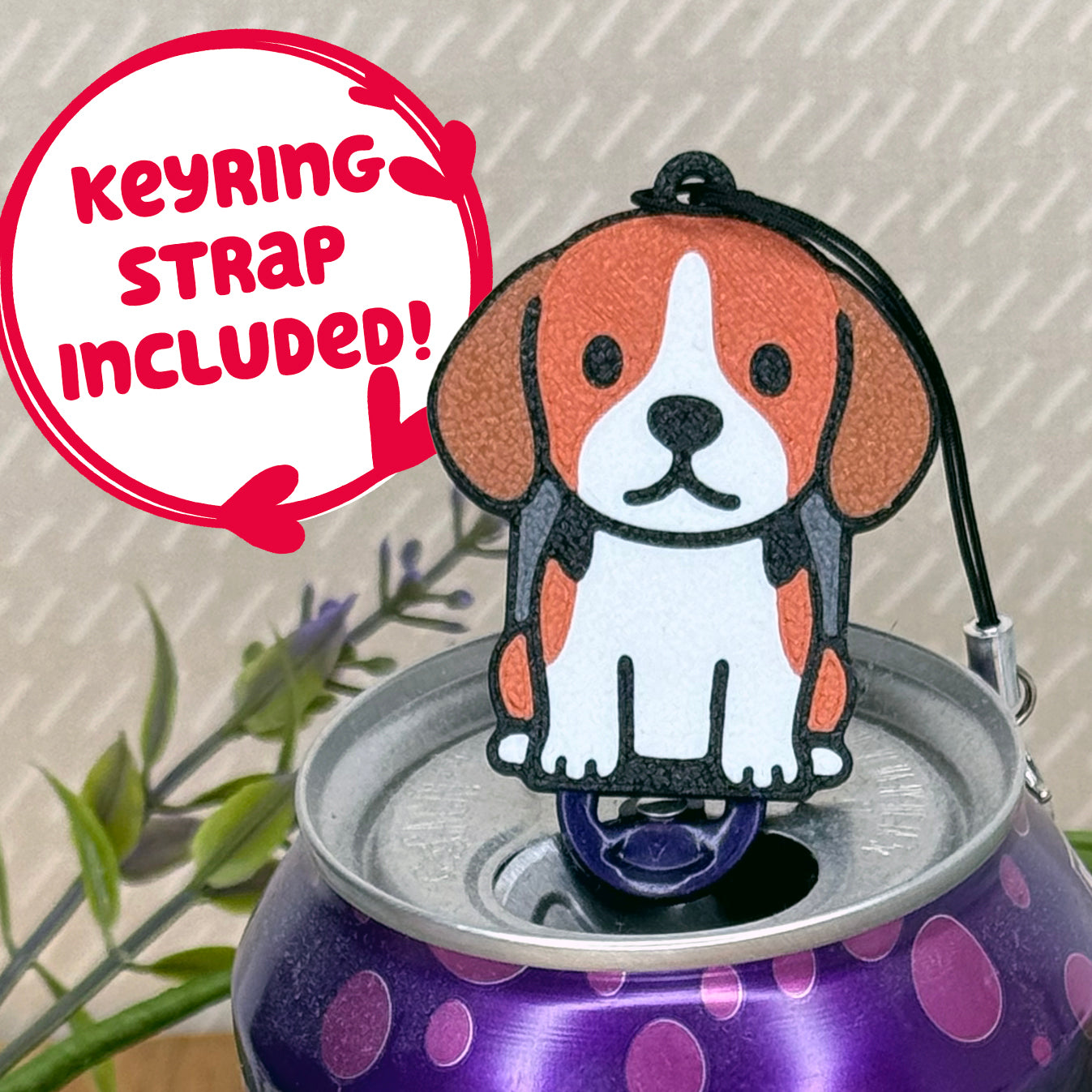 A cute Beagle design Tab Buddy rests atop an open can of sparkling water. Text bubble reads, "Keyring Strap Included!"