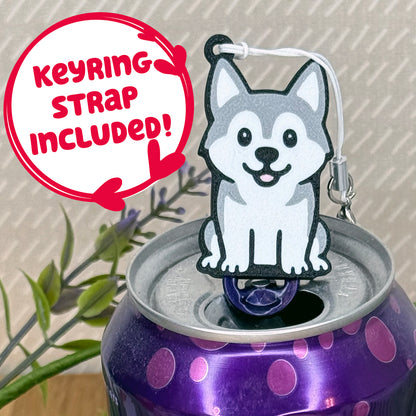 A cute grey and white Husky design Tab Buddy rests atop an open can of sparkling water. Text bubble reads, "Keyring Strap Included!"