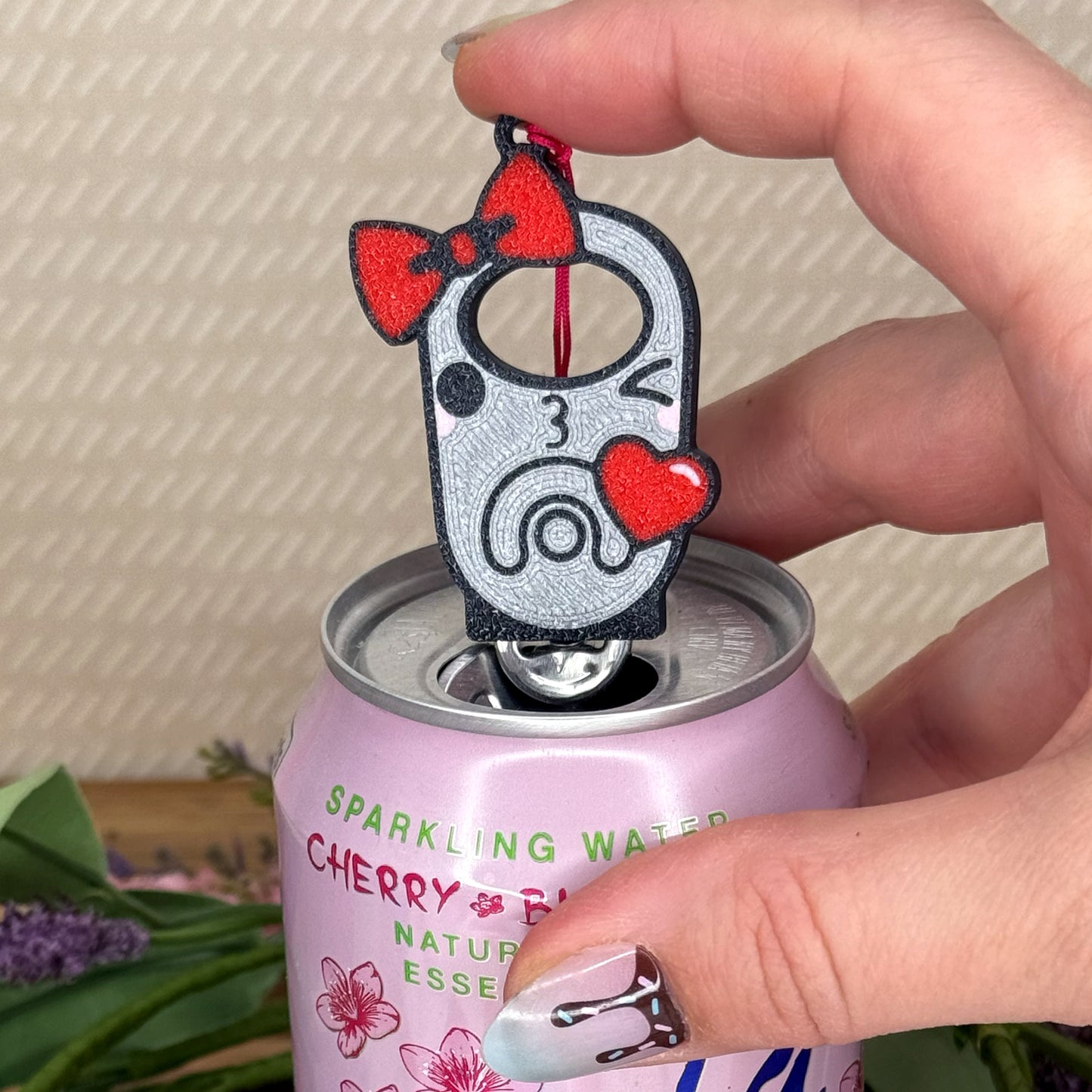 Tab Buddy with cartoon design of a winking tab blowing a heart on a can of sparkling water