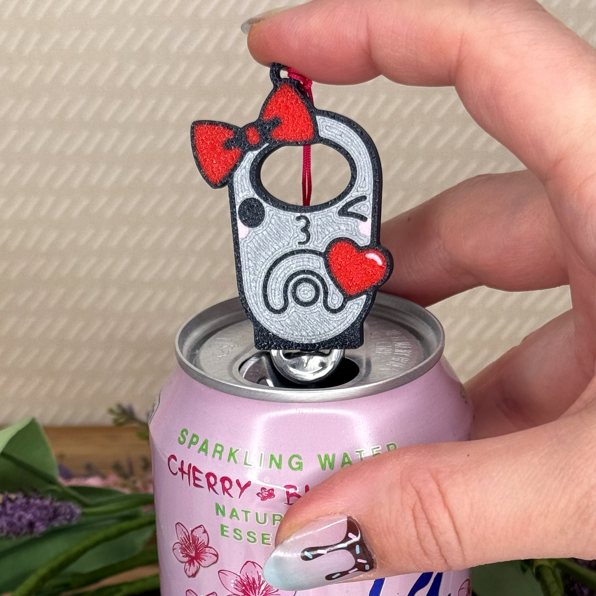 Tab Buddy with cartoon design of a winking tab blowing a heart on a can of sparkling water