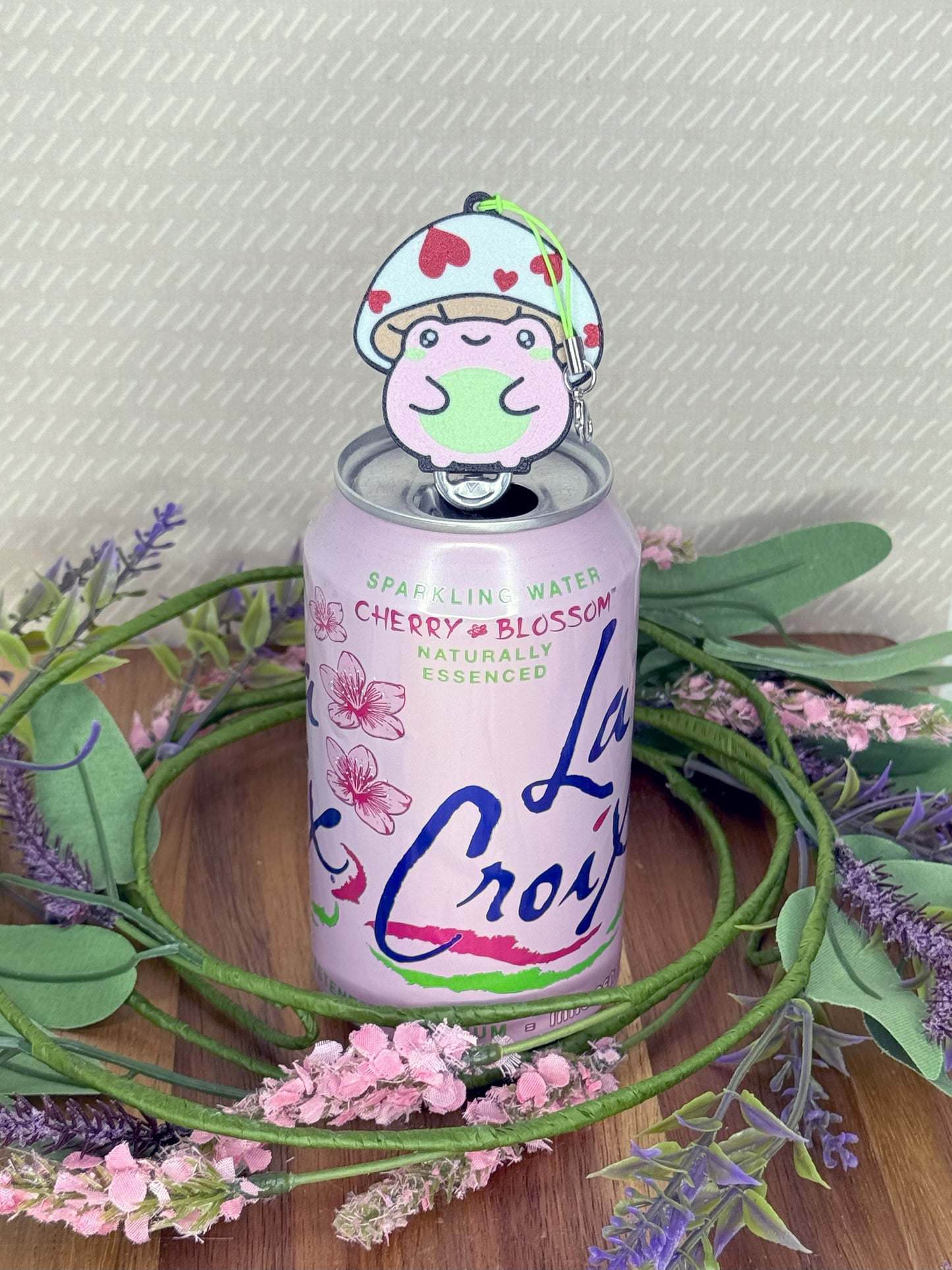 Cherry blossom water can with a pink frog Tab Buddy on a floral wreath.