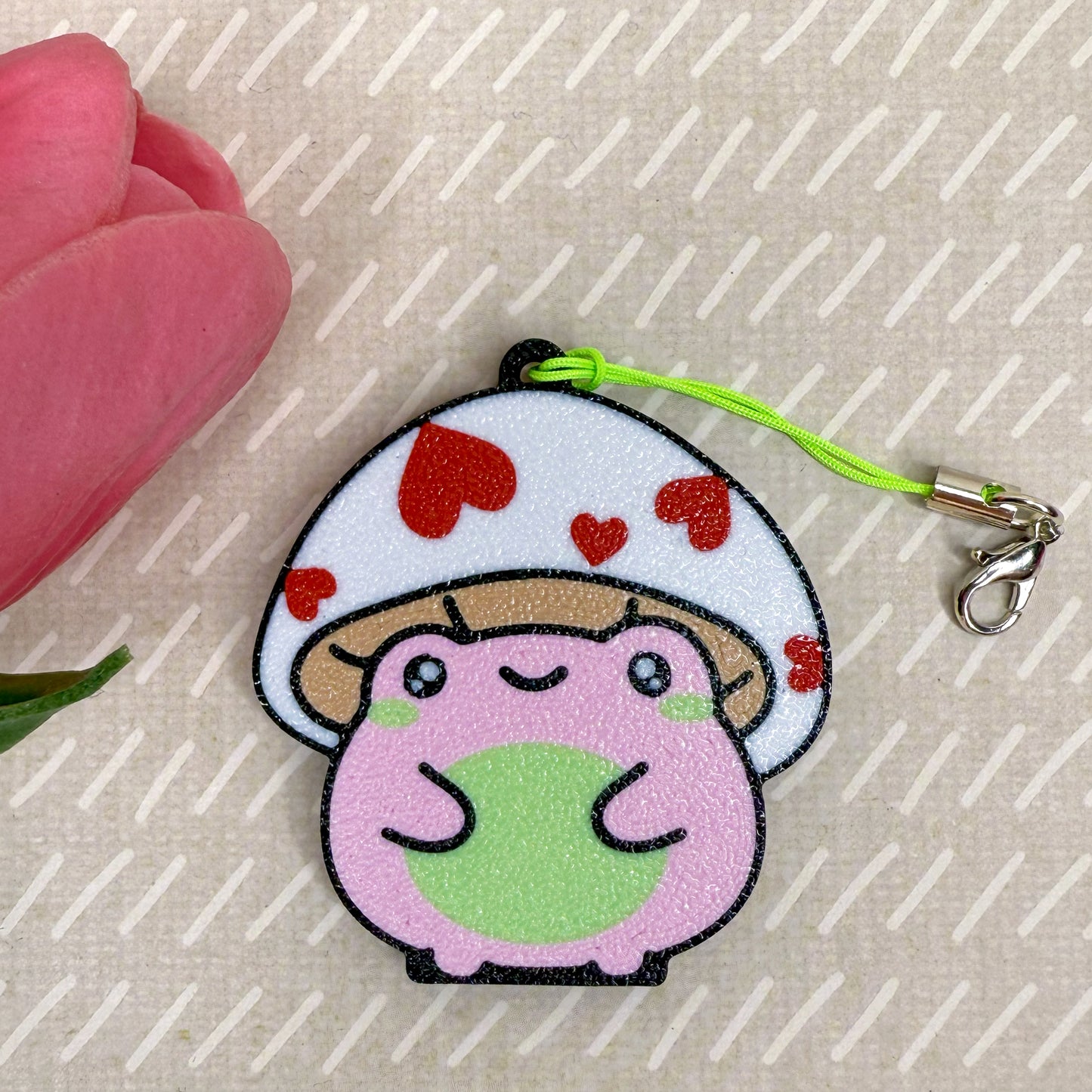 Cute cartoon mushroom frog Tab Buddy with red hearts on a beige background