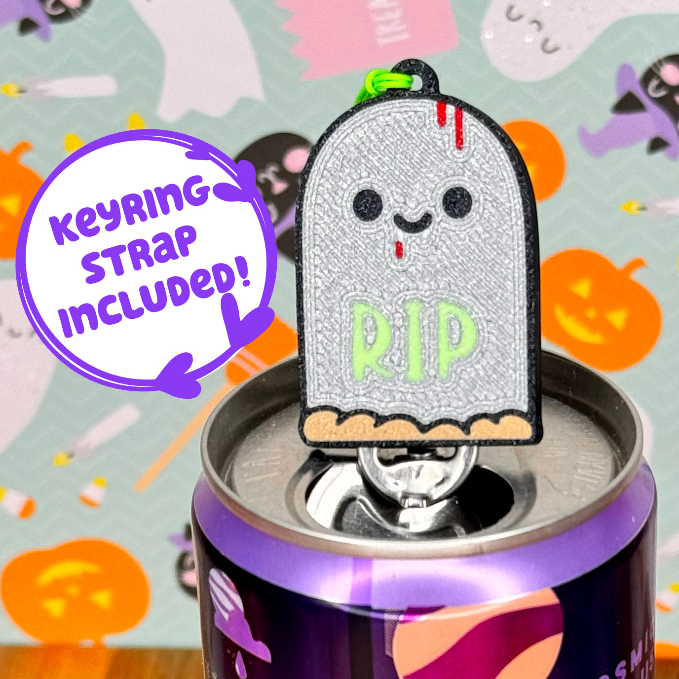 Tombstone-shaped Tab Buddy with keyring strap on a Halloween-themed background text reads 'keyring strap included!'