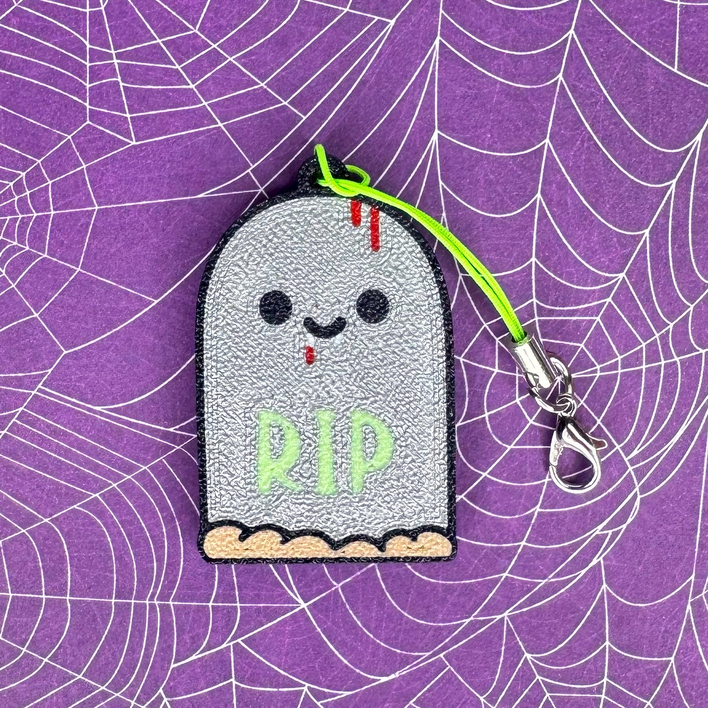 Ghostly tombstone Tab Buddy with 'RIP' on a spider web background