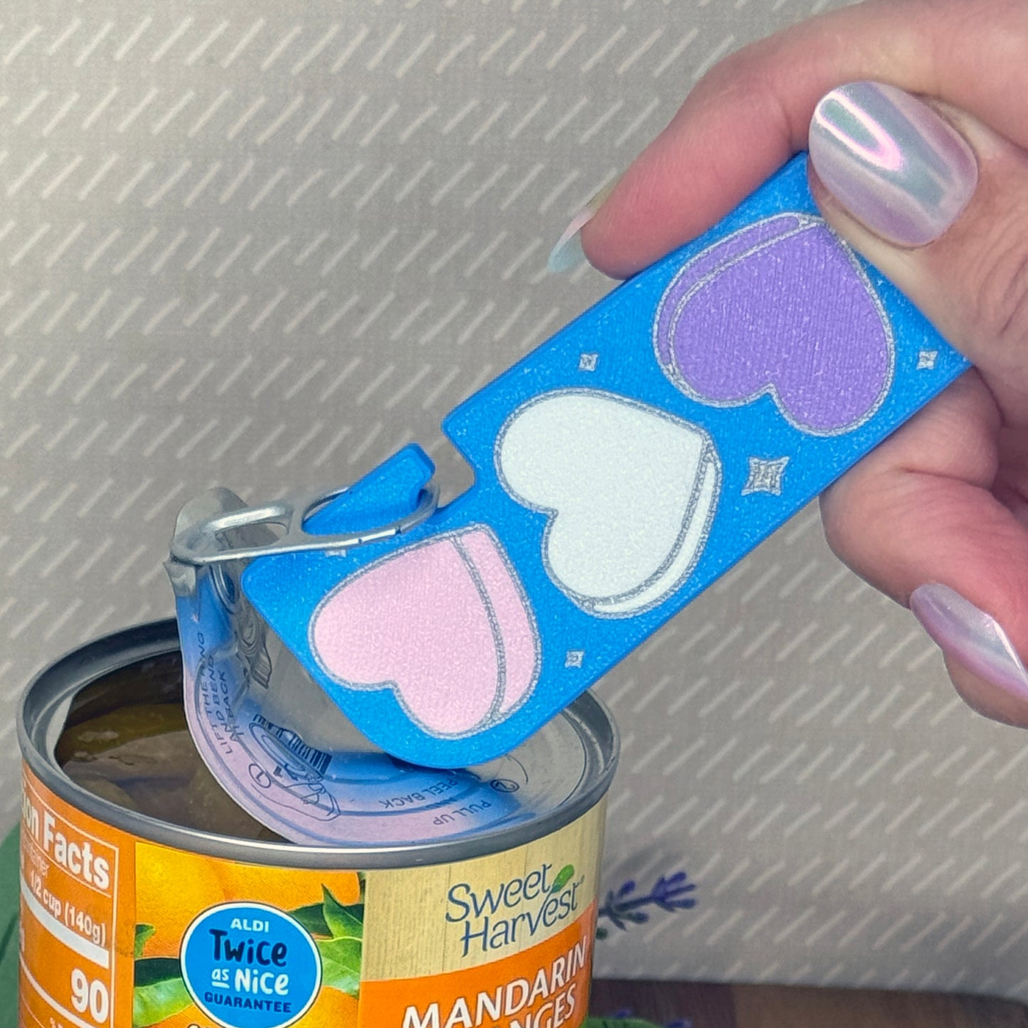 Blue Tab Buddy XL with Candy Hearts design is used to open a can of mandarin oranges.