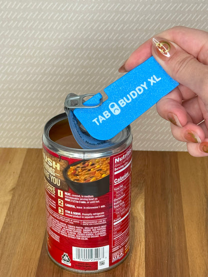 Person using a blue Tab Buddy XL can opener on a can of soup.