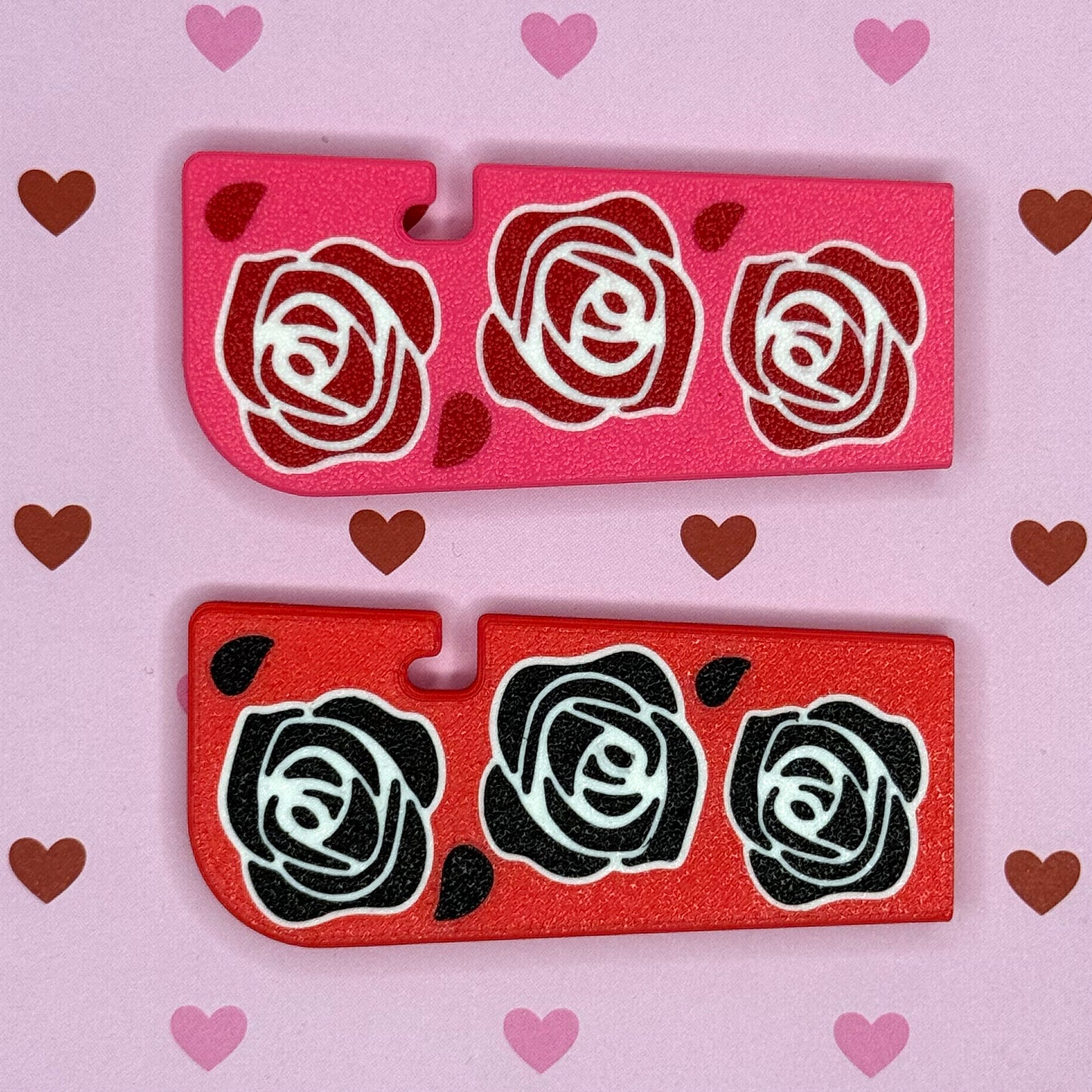 TwoTab Buddy XLs with rose designs on a pink background with hearts.