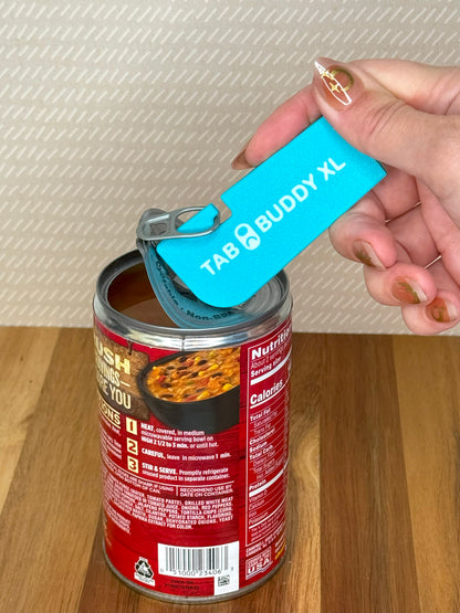 Hand using a turquoise Tab Buddy XL can opener on a can of food.