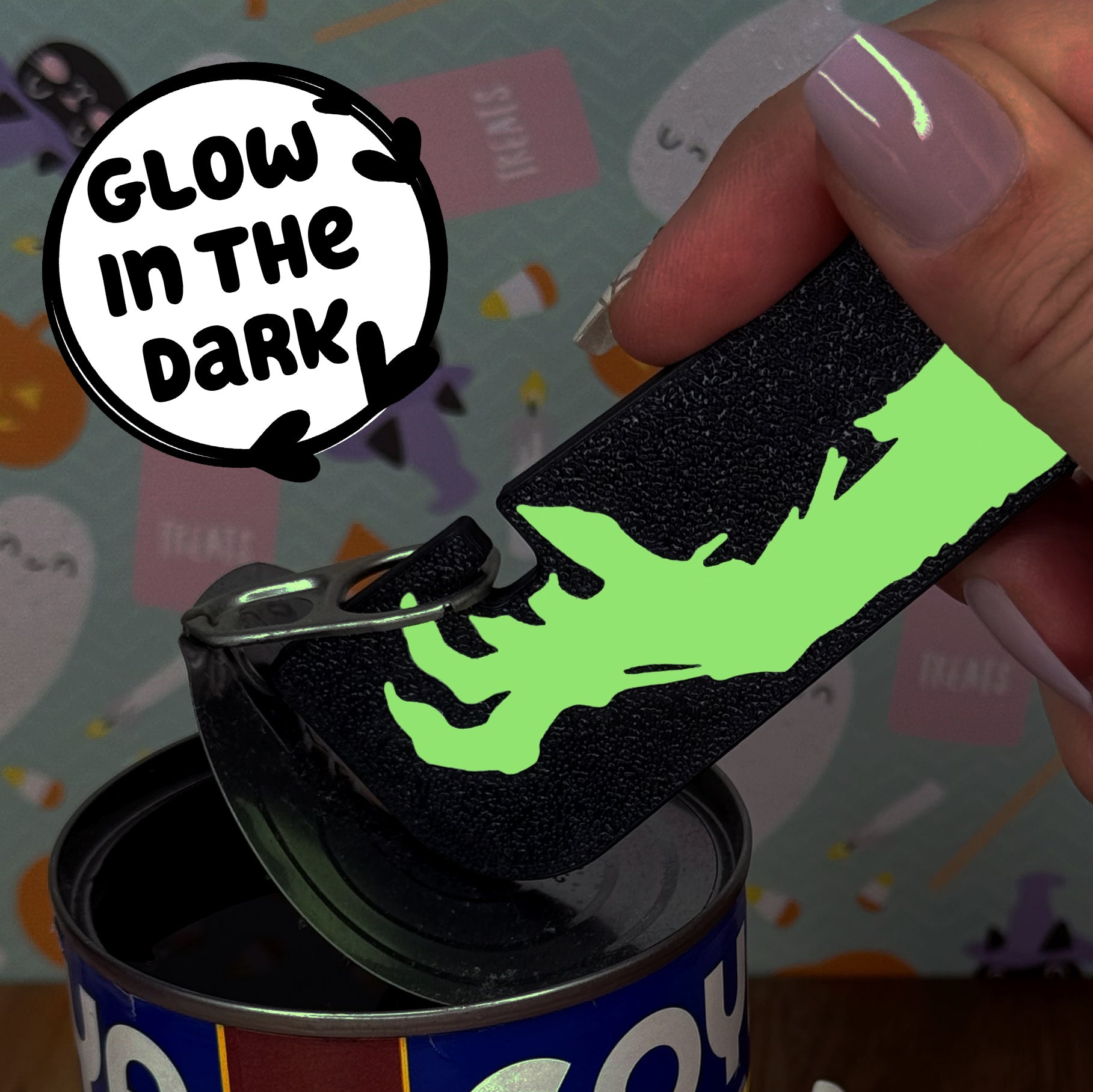 Glow-in-the-dark Tab Buddy XL with a opens a can against a colorful background.