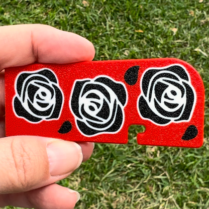 Red Tab Buddy XL with black rose designs held by a hand on grass