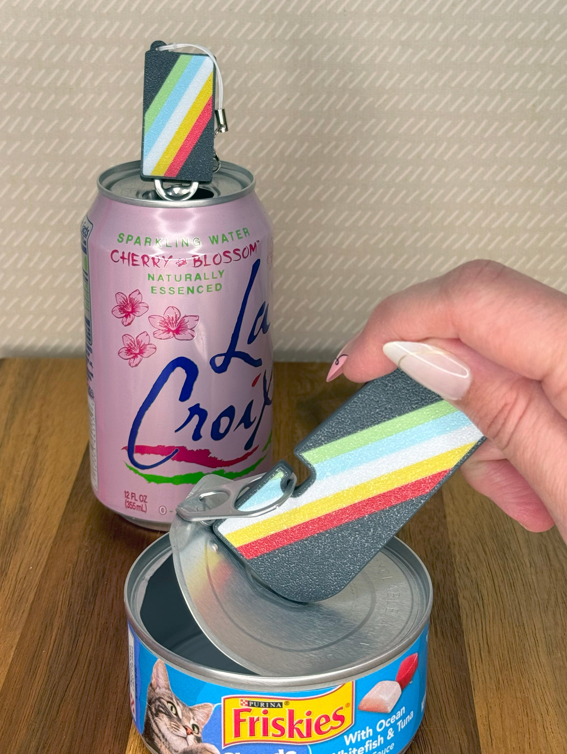 Hand using a colorful Tab Buddy XL on a Friskies cat food can 