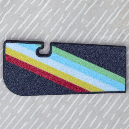 Colorful striped disability pride Tab Buddy XL on a textured beige background