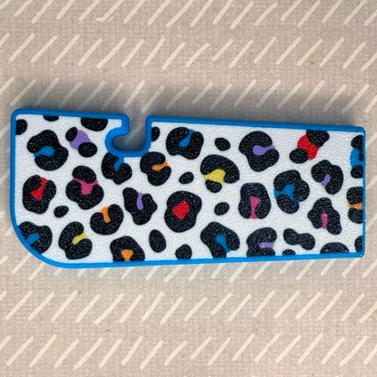 Rainbow leopard print Tab Buddy XL rests on a beige surface