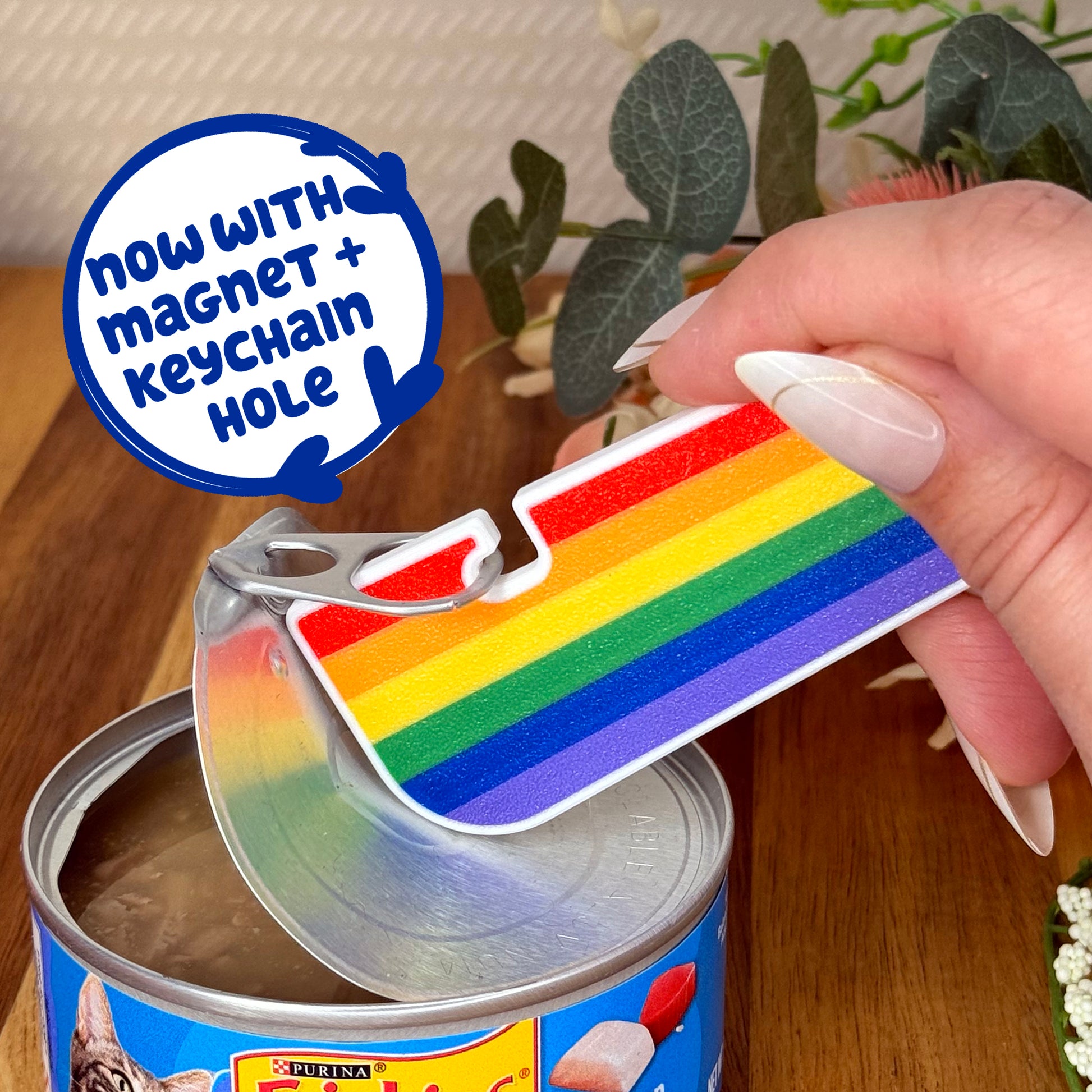 Rainbow-colored Tab Buddy XL held over a can, with text indicating 'now with magnet + keychain hole'.