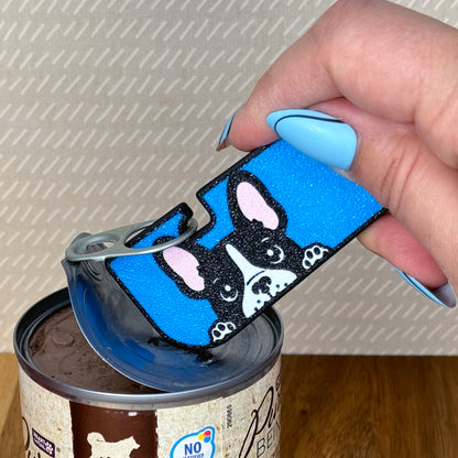 Hand using a blue dog-themed Tab Buddy XL on a can.