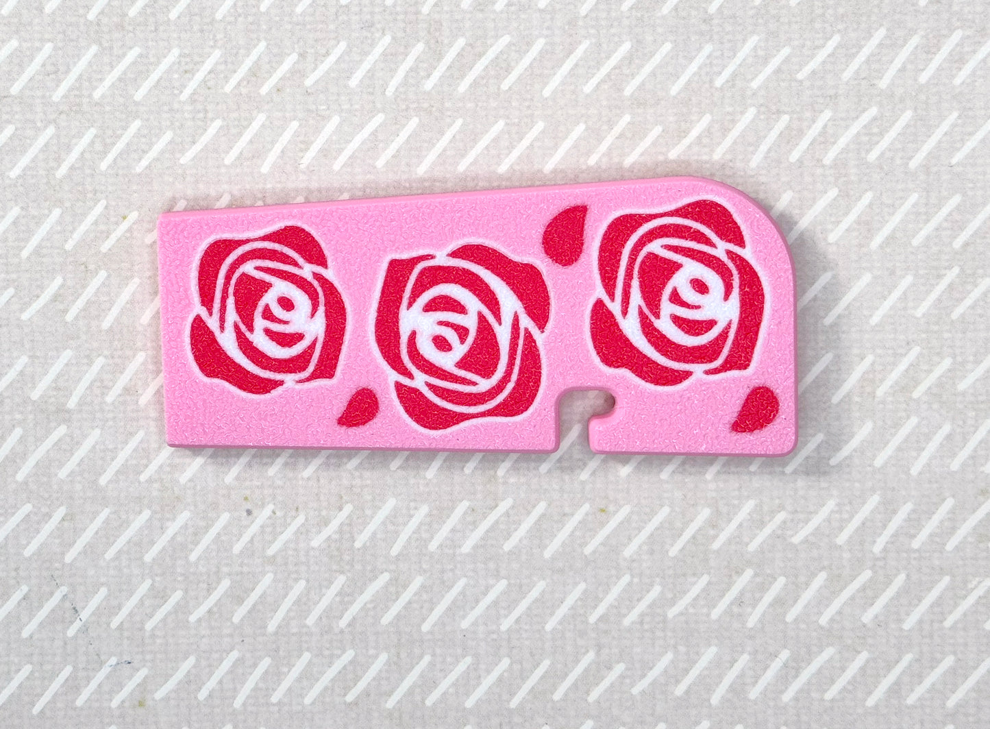 Pink Tab Buddy XL with rose designs on a beige background