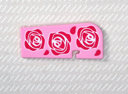 Pink Tab Buddy XL with rose designs on a beige background