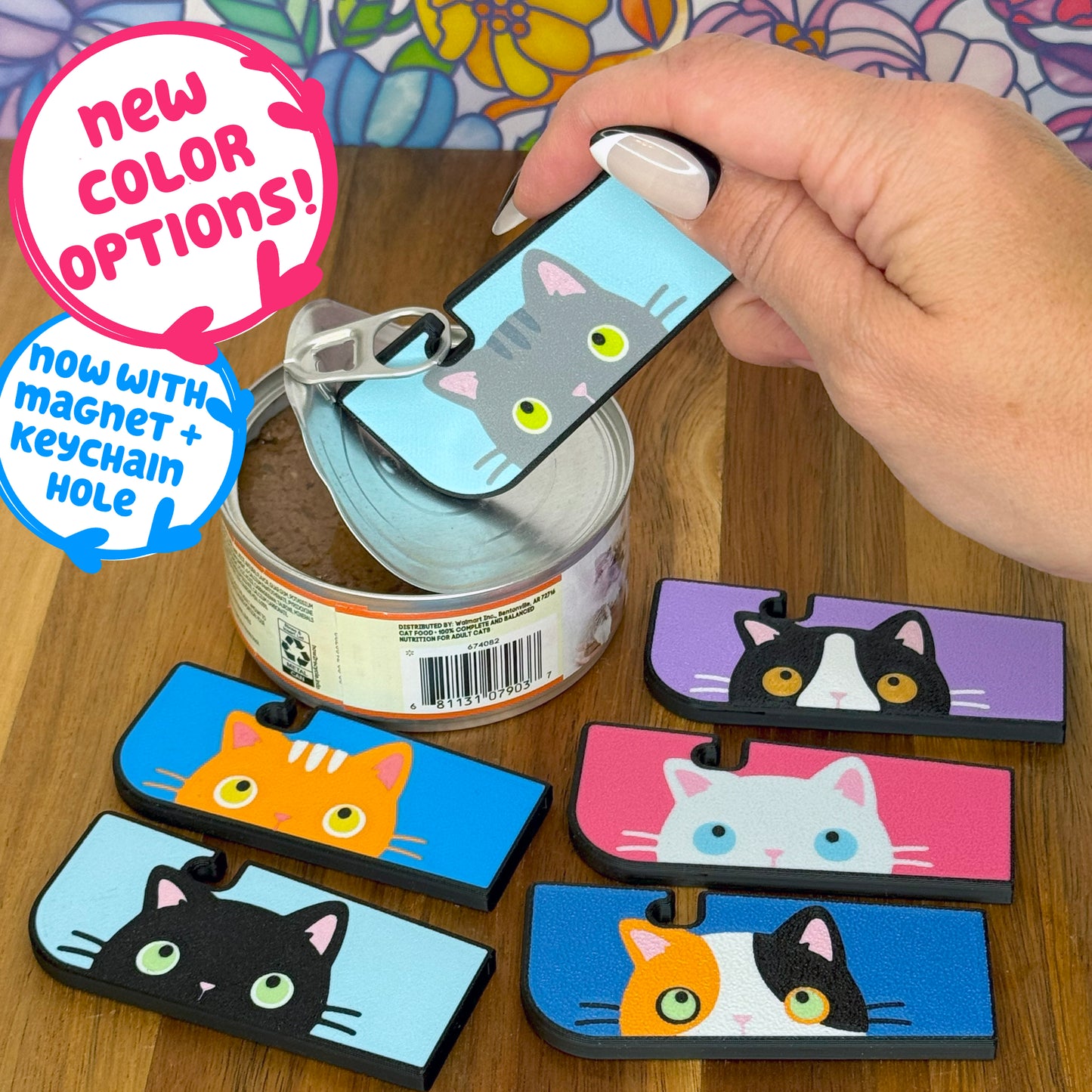 Cat-themed Tab Buddies can openers with colorful designs on a wooden surface